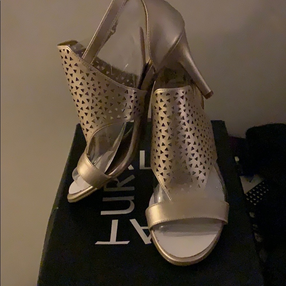 Gold metallic high heeled sandals.